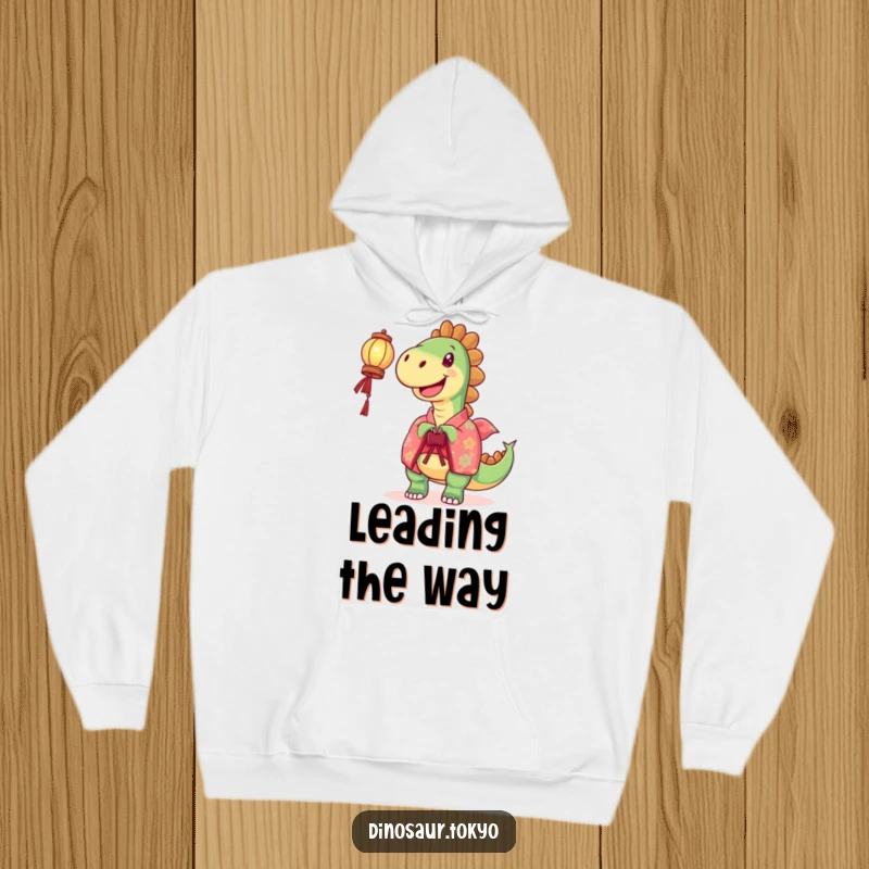 Funny Hoodie: A joyful dinosaur in a vibrant kimono holds a lantern, offering humorous warmth and a shining design.