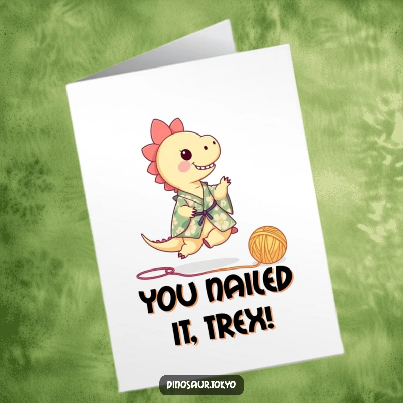 Funny Free Printable Congratulations Card: Tiny dinosaur in floral kimono playfully kicks yarn, celebrating success with a smile.